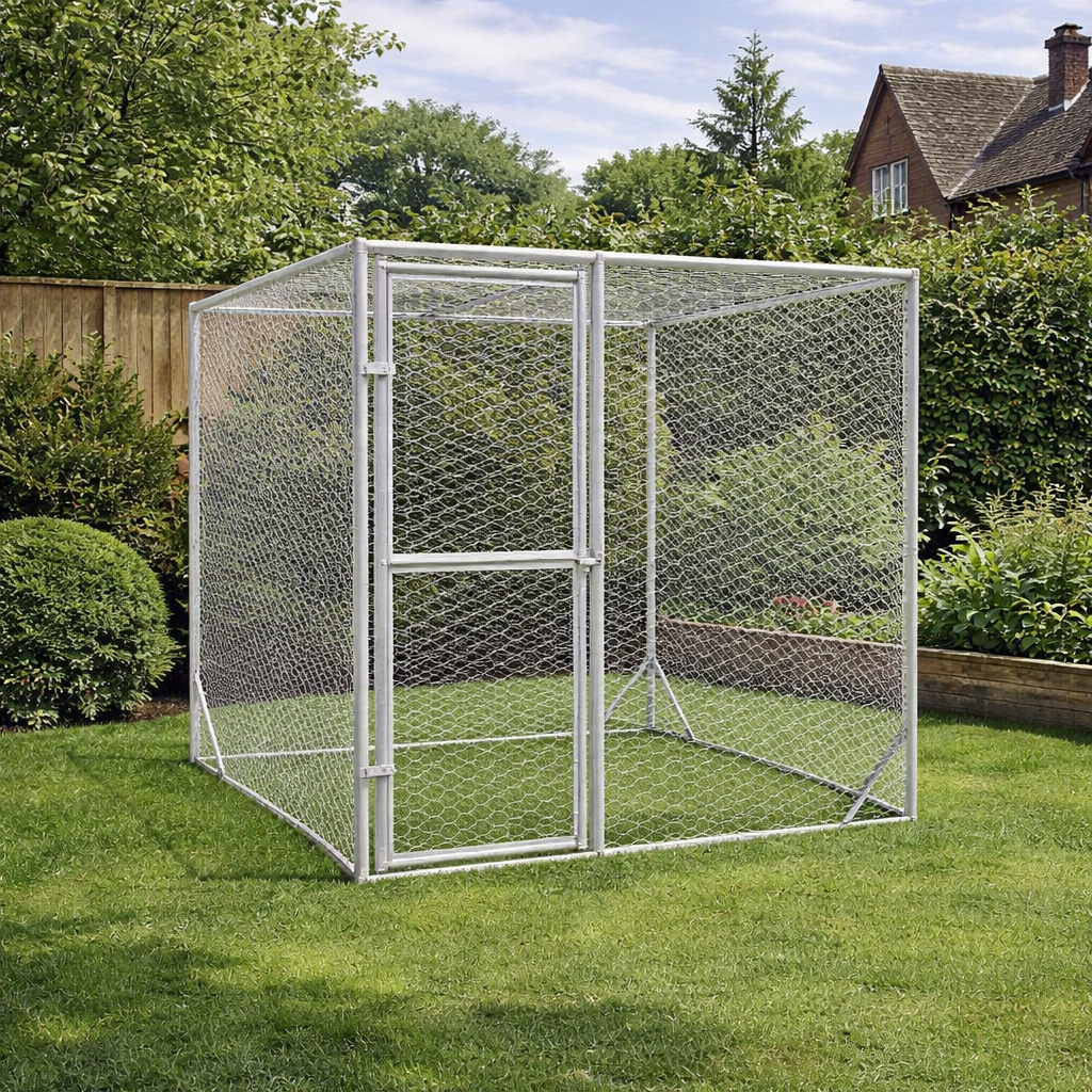 Outdoor dog run made from galvanised steel installed on lawn in garden setting with fence and trees